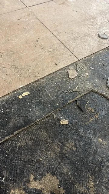 Black bitumen mastic floor removal in a W2 flat